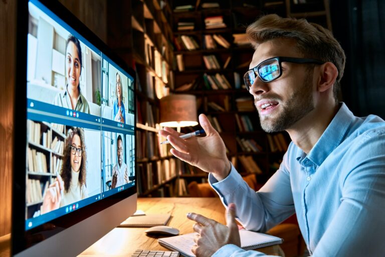 Business man talking with diverse colleagues in virtual video conference chat.