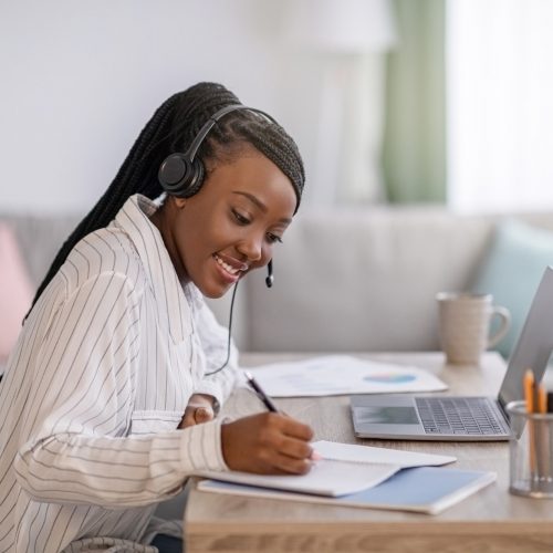 Joyful african american woman attending online course